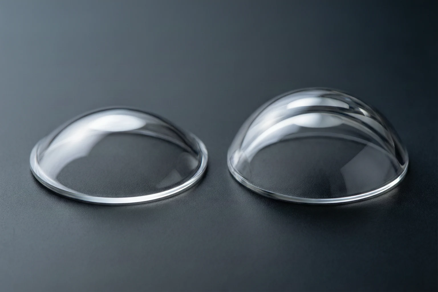 Single-domed and double-domed sapphire watch crystals compared on a technical workbench